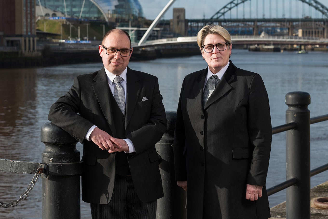 The team from WS Harrison funeral directors in Whitley Bay stand together wearing smart uniforms